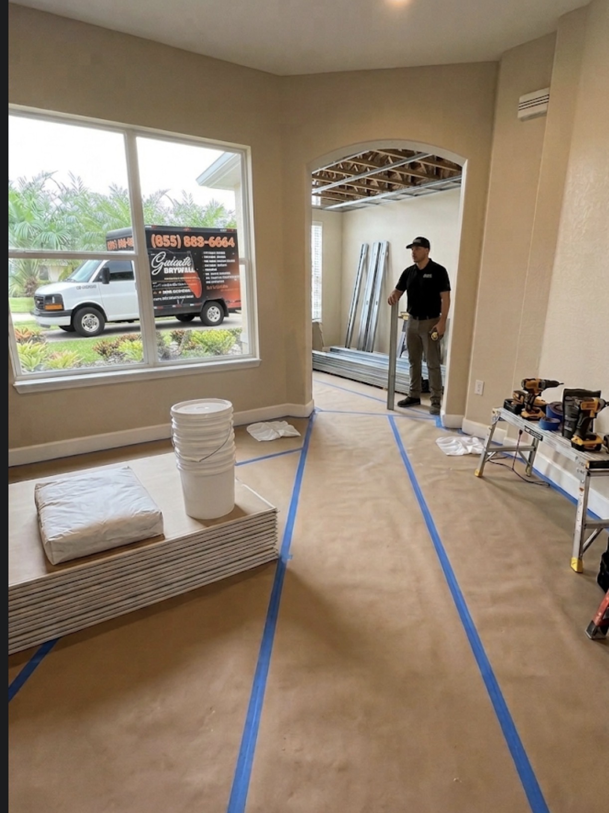 Prepared room with drywall staged and crew on site before installation