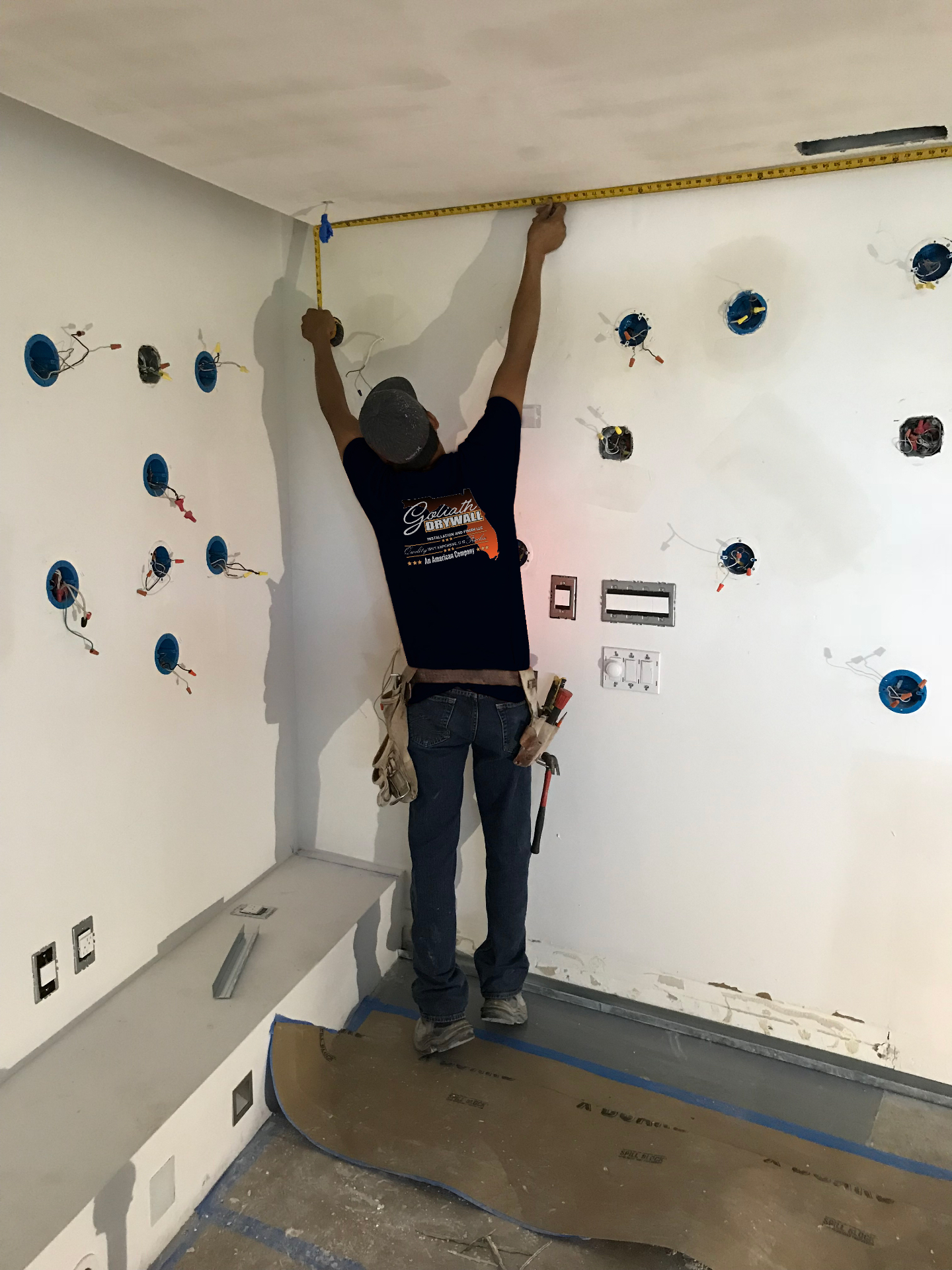 Crew skim coating a ceiling