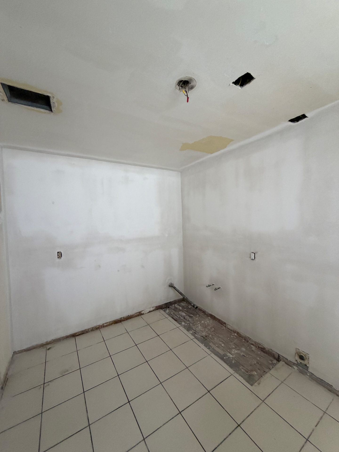 Kitchen after moisture board installation and skim-coated finish